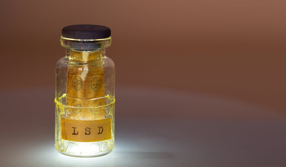 A small bottle with acid tabs and the letters "lsd" -is it illegal in california?