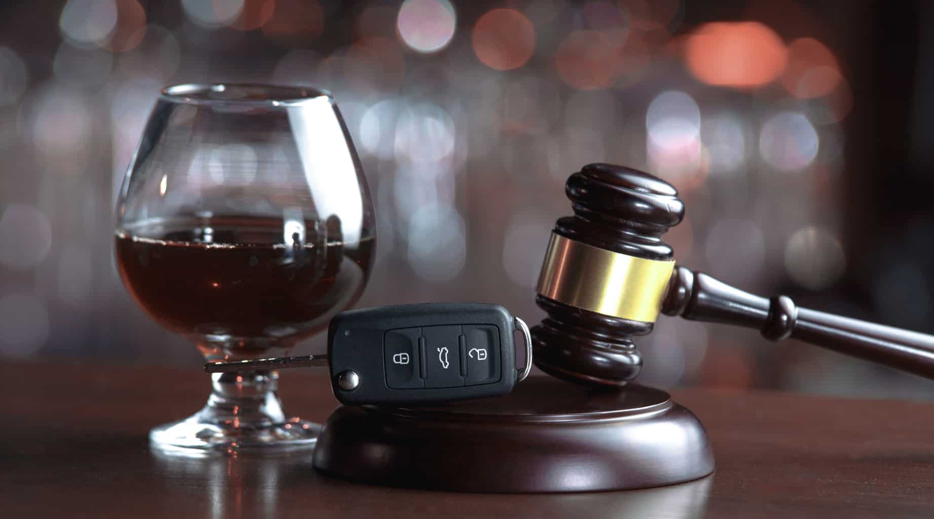 a cup of brandy, a gavel and car keys
