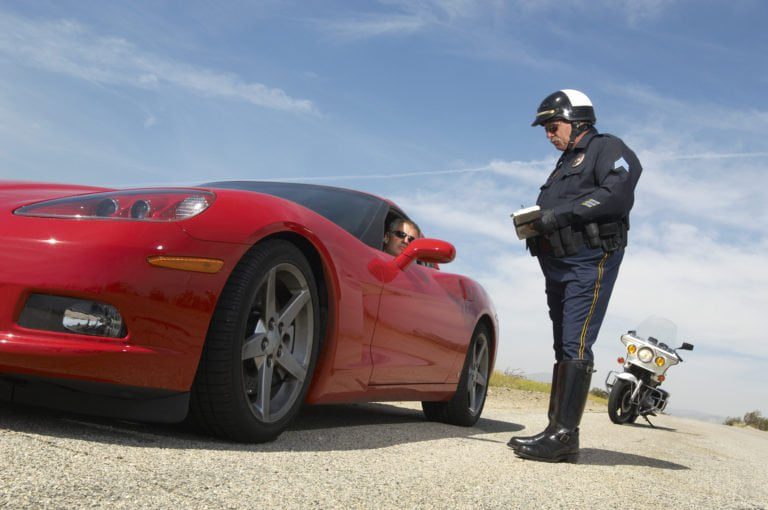 Traffic Cop Talking with Driver of Red Sports Car